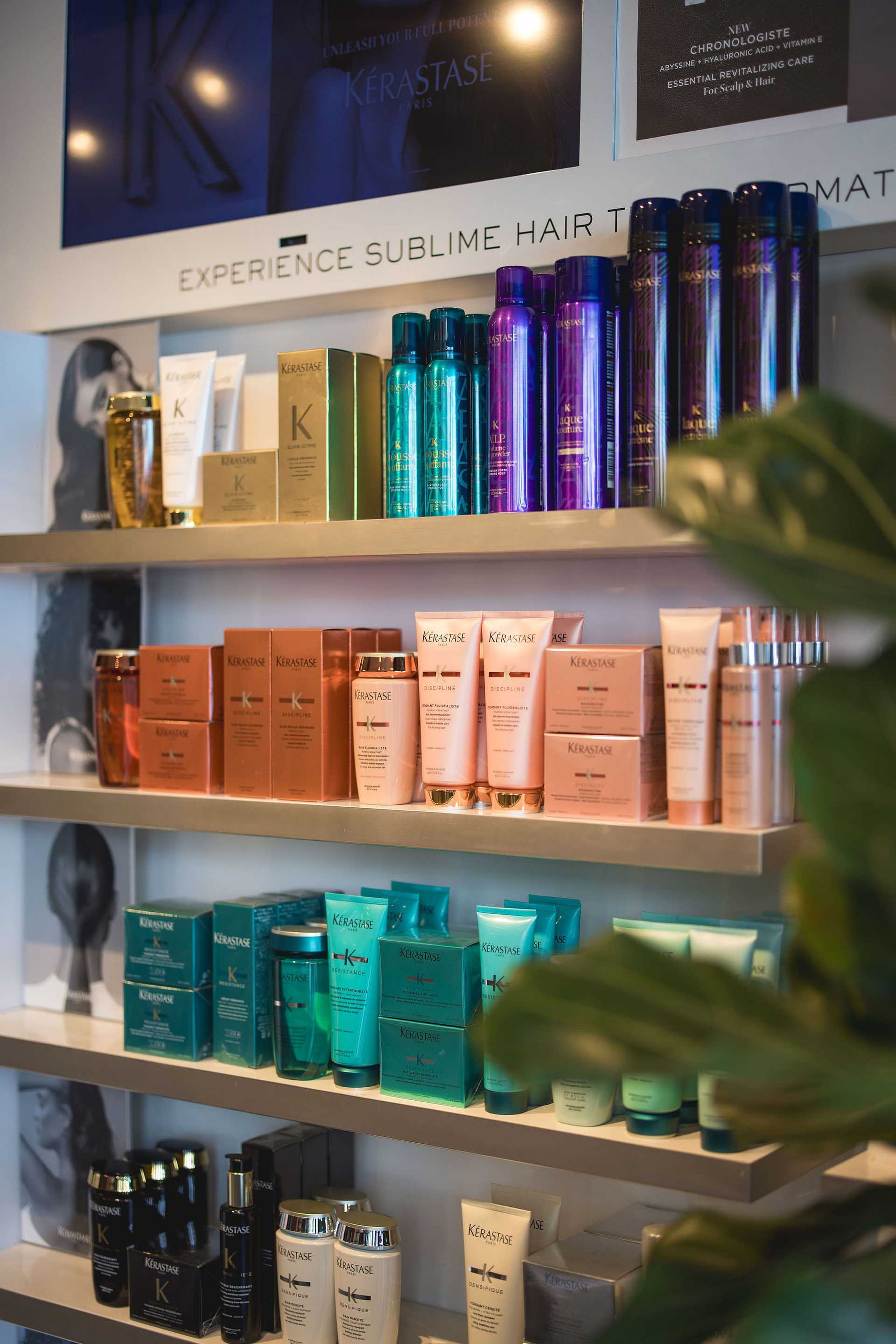 Shelves of hair care products with various colorful bottles and boxes from the brand Kérastase.